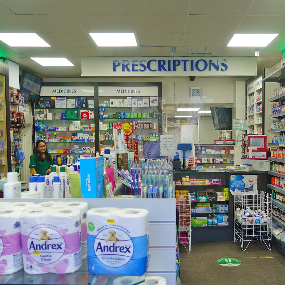 Inside a pharmacy showing the prescription counter